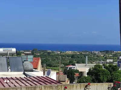 a view of a city with the ocean in the background at michaelas traditional house in Phanaes