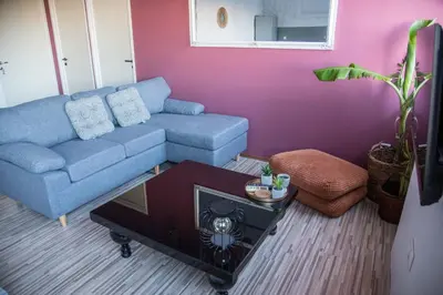 a living room with a blue couch and a table at mandala central apartment in Rhodes Town