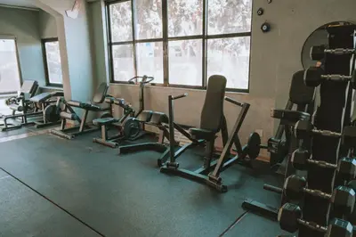 a gym with several rows of exercise equipment in a room at mandala central apartment in Rhodes Town