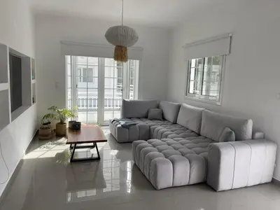 a living room with a couch and a table at Luminous Home City Rhodes in Rhodes Town