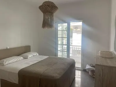 a bedroom with a bed and a chandelier at Luminous Home City Rhodes in Rhodes Town
