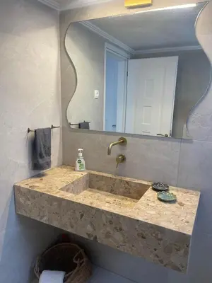 a bathroom with a sink with a large mirror at Luminous Home City Rhodes in Rhodes Town