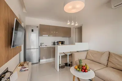 a living room with a couch and a table with fruit on it at Prasonisi Villas in Kattavía