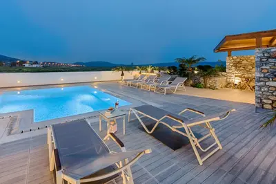 a villa with a swimming pool on a wooden deck at Prasonisi Villas in Kattavía
