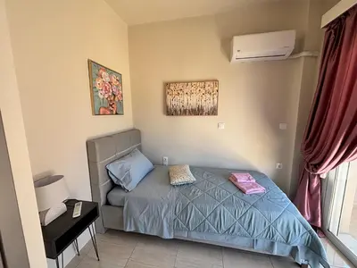 a small bedroom with a bed and a window at Erato Sea View Villa in Koskinou