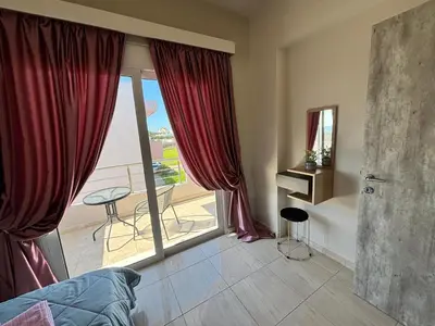 a bedroom with a large window with a view at Erato Sea View Villa in Koskinou