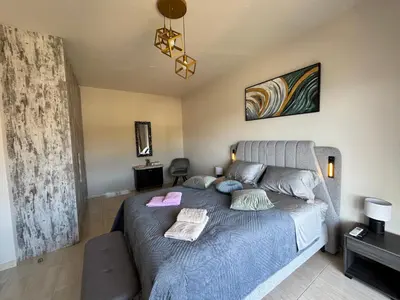 a bedroom with a bed with a blue comforter at Erato Sea View Villa in Koskinou
