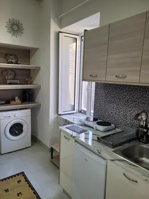 a kitchen with a sink and a washing machine at Sebastian Luxury House in Rhodes Town
