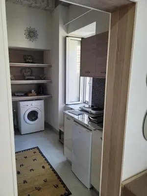 a small kitchen with a washing machine and a window at Sebastian Luxury House in Rhodes Town
