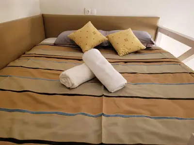 a bed with two towels and pillows on it at Sebastian Luxury House in Rhodes Town