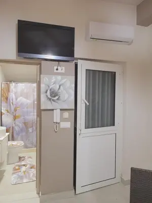 a room with a door and a tv on the wall at Sebastian Luxury House in Rhodes Town