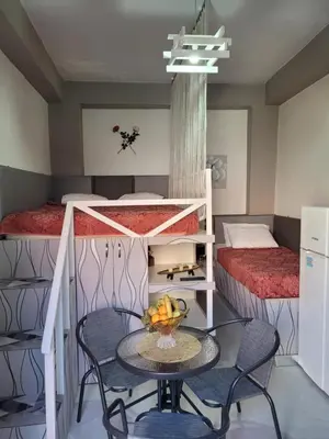a room with a table and two bunk beds at Sebastian Luxury House in Rhodes Town