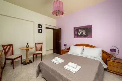 a bedroom with a bed and a table and chairs at Stavroulas Amazing House in Phanaes