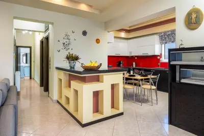 a kitchen with a large island in the middle at Stavroulas Amazing House in Phanaes