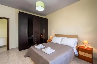 a bedroom with a bed with two towels on it at Stavroulas Amazing House in Phanaes