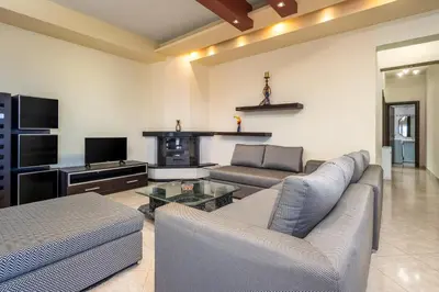 a living room with a couch and a fire place at Stavroulas Amazing House in Phanaes