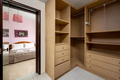 a bedroom with a bed and a walk in closet at Stavroulas Amazing House in Phanaes