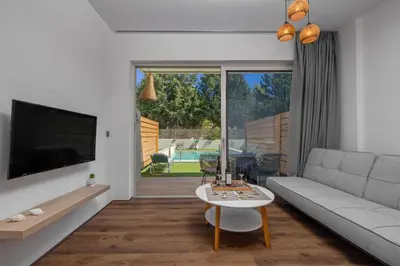 a living room with a couch and a table at M&B Luxury Suites Charaki in Haraki