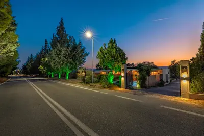 an empty street at night with a street light at M&B Luxury Suites Charaki in Haraki