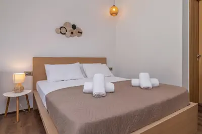 a bedroom with a large bed with white pillows at M&B Luxury Suites Charaki in Haraki