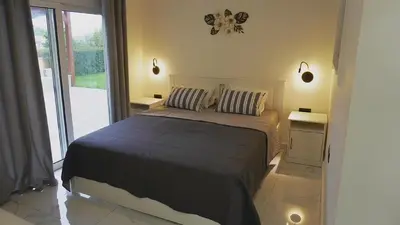 a bedroom with a large bed with two night stands at Villa Sephora in Faliraki