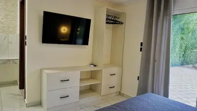 a bedroom with a tv on the wall and a bed at Villa Sephora in Faliraki
