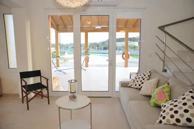 a living room with a couch and a table at Villa Sephora in Faliraki