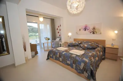 a bedroom with a bed and a chandelier at Villa Sephora in Faliraki