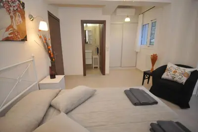 a room with a bed and a couch and a chair at Villa Sephora in Faliraki