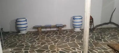 three blue and white vases sitting next to a bench at Ageri & Tritonis Luxury Apartments in Pefki Rhodes