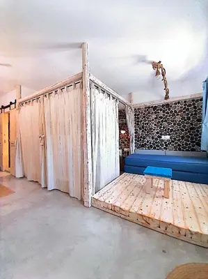 a room with a bed and a window with curtains at Ageri & Tritonis Luxury Apartments in Pefki Rhodes