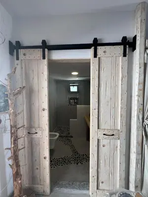 an open door to a bathroom with a toilet at Ageri & Tritonis Luxury Apartments in Pefki Rhodes