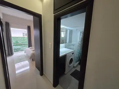 a bathroom with a mirror and a washing machine at Konnet Apartment #2 in Rhodes Town