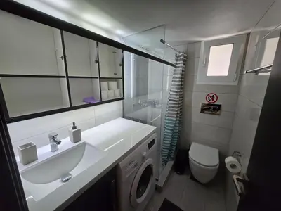 a bathroom with a sink and a toilet at Konnet Apartment #2 in Rhodes Town