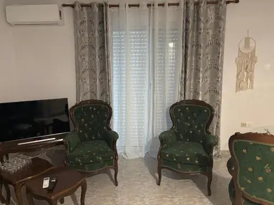 a living room with two chairs and a television at rosi rhodos in Rhodes Town