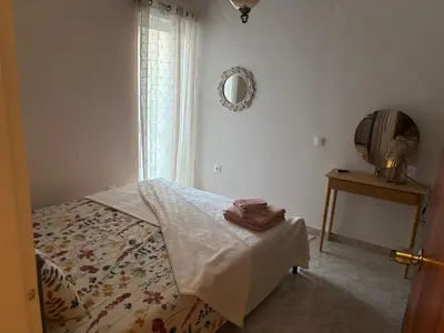 a bedroom with a bed and a mirror and a table at rosi rhodos in Rhodes Town