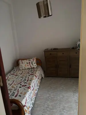 a small bedroom with a bed and a dresser at rosi rhodos in Rhodes Town