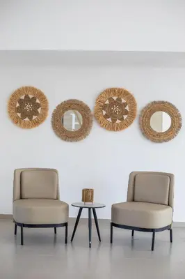 two chairs and a table in a room with mirrors at Lime Hotel Faliraki in Faliraki