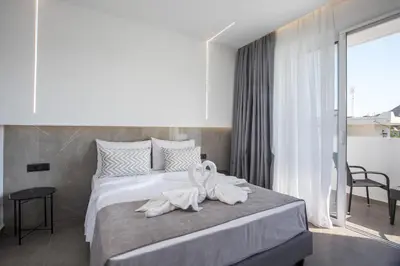 a bedroom with two swans sitting on a bed at Lime Hotel Faliraki in Faliraki
