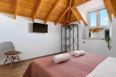 a bedroom with a bed with two towels on it at Kostas Nest in Ialyssos