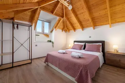 a bedroom with a bed with two towels on it at Kostas Nest in Ialyssos