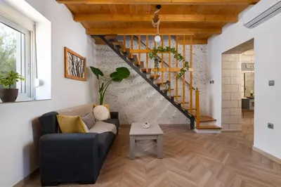 a living room with a couch and a table at Kostas Nest in Ialyssos