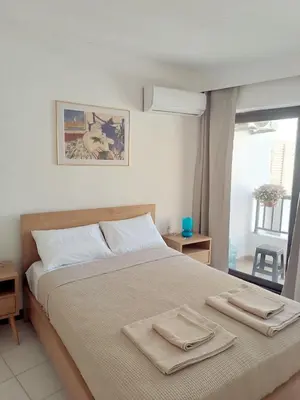 a bedroom with a bed with two towels on it at Apartment in Rhodes town and near the beach in Rhodes Town
