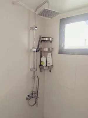 a shower in a bathroom with a window at Apartment in Rhodes town and near the beach in Rhodes Town