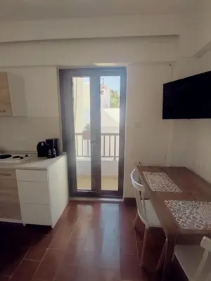 a kitchen with a table and a view of a balcony at Apartment in Rhodes town and near the beach in Rhodes Town