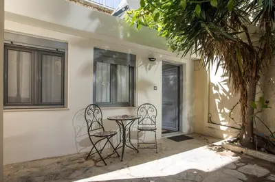 two chairs and a table in front of a house at Paradise City Apartment in Rhodes Town