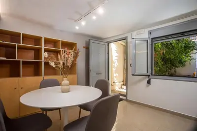 a dining room with a white table and chairs at Paradise City Apartment in Rhodes Town