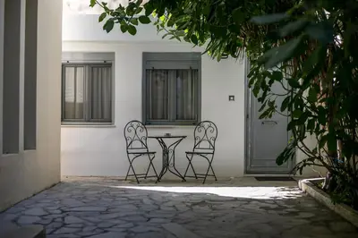 two chairs and a table in front of a house at Paradise City Apartment in Rhodes Town