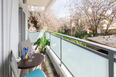 a balcony with a table and chairs on a balcony at Eln's Sunlit Apartment in Rhodes Town
