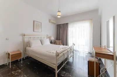 a bedroom with a bed and a piano at Eln's Sunlit Apartment in Rhodes Town
